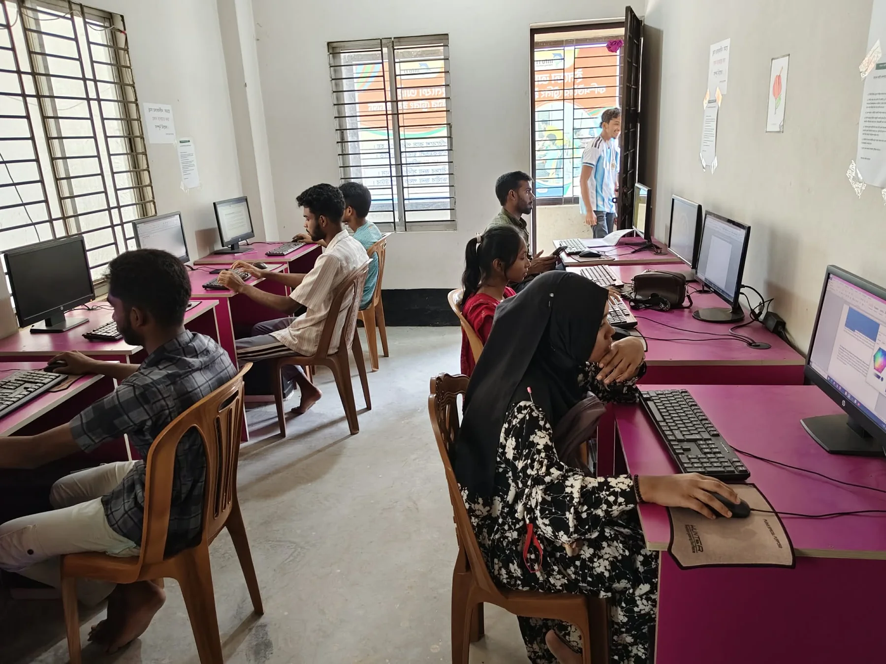 Students practicing computer skills at Info IT
